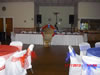 A red and blue-themed setup in rental hall showing head table