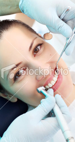 Woman with brilliant smile getting teeth cleaned